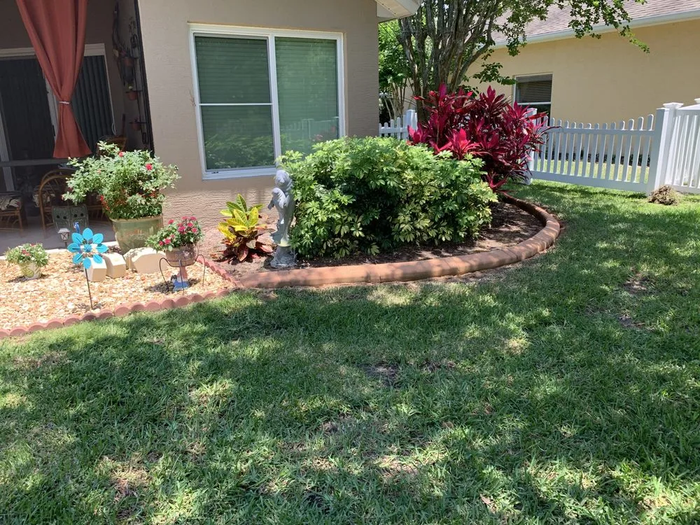 Professional lawn mowing service with custom design in Port Orange, FL by Visual Impact Curbing