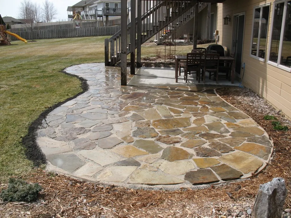 Custom landscape installation with custom design in Omaha, NE by Well Rooted Gardens