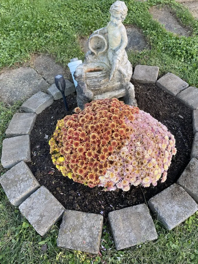 Professional garden landscaping with custom design across Albany, OH - Woman’s Tree Trimming Cutting Down Trees and Landscaping